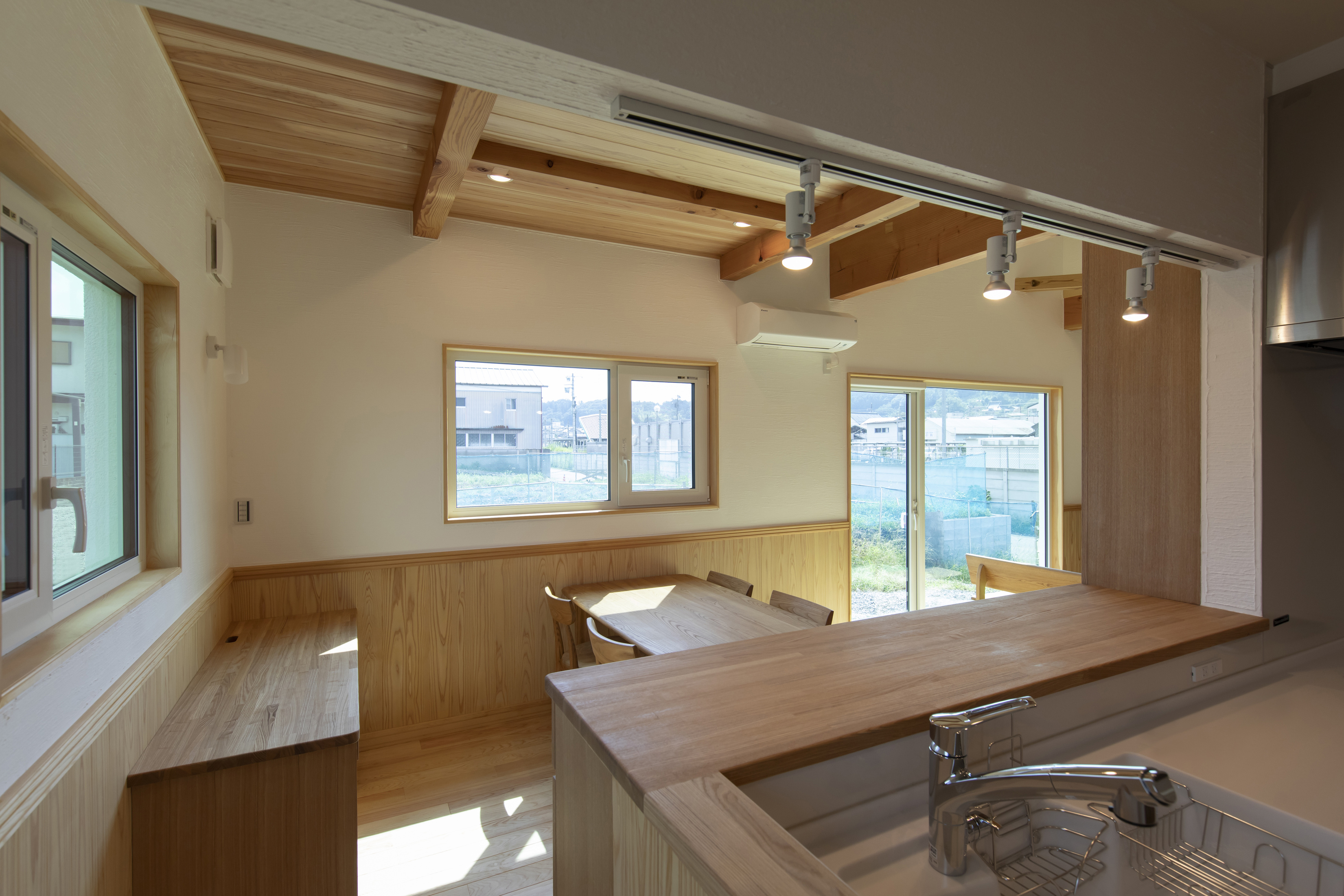 木製の腰壁とデスクが一体となった明るいワークスペースのある家 - photo 13